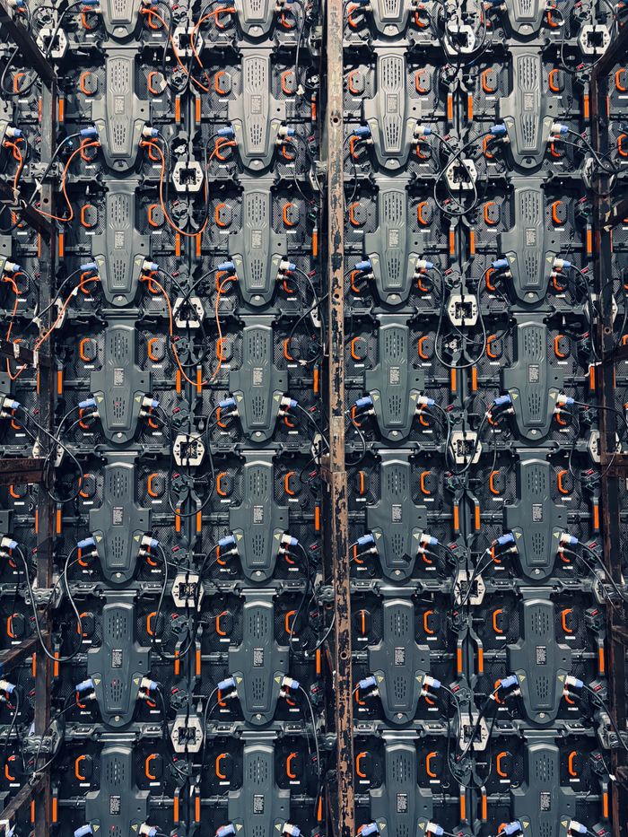 Close-up of a detailed circuit board panel with multiple wires and connectors in an industrial setting.